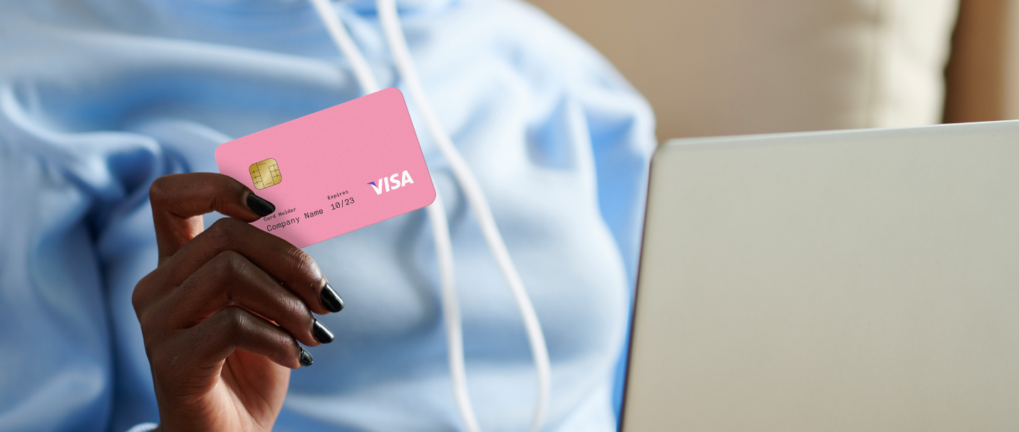 4 Ways to Increase Your E-commerce Conversion Rate. A woman at home online shopping holding a pink credit card.