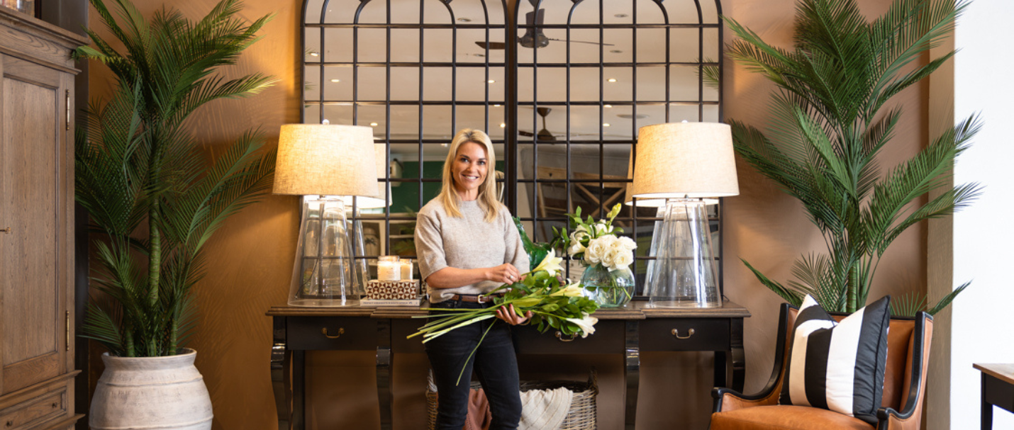Tammy Holmes from Ivy Decor and design stands in front of a styled console table at Block & Chisel