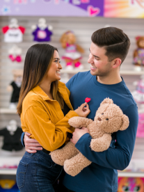 Couple holding teddy bear.
