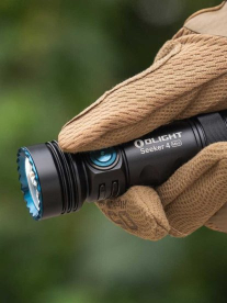 Flashlight in a hand with a glove